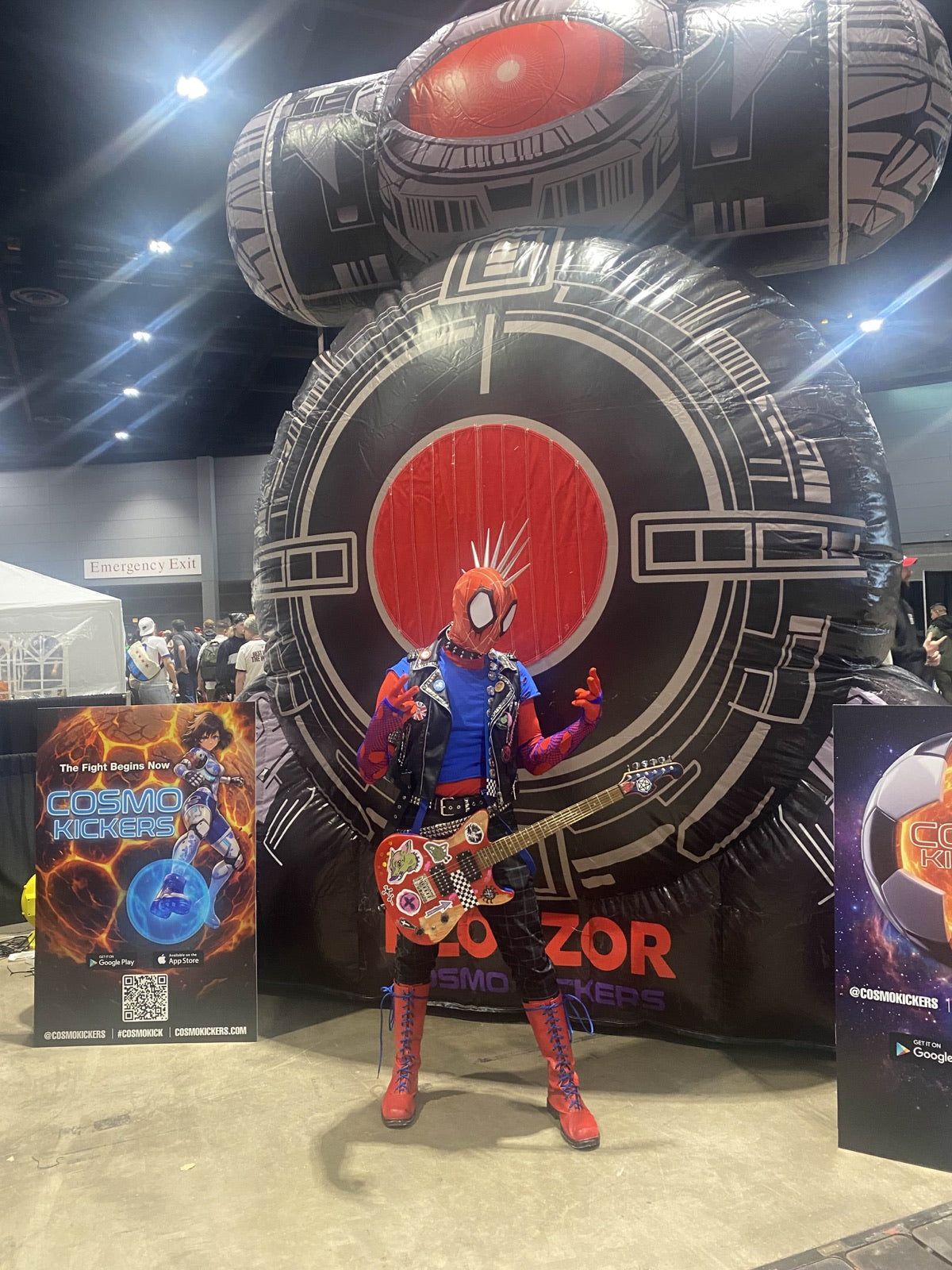 Costumed guest posing in front of the Boss Fight Targets inflatable