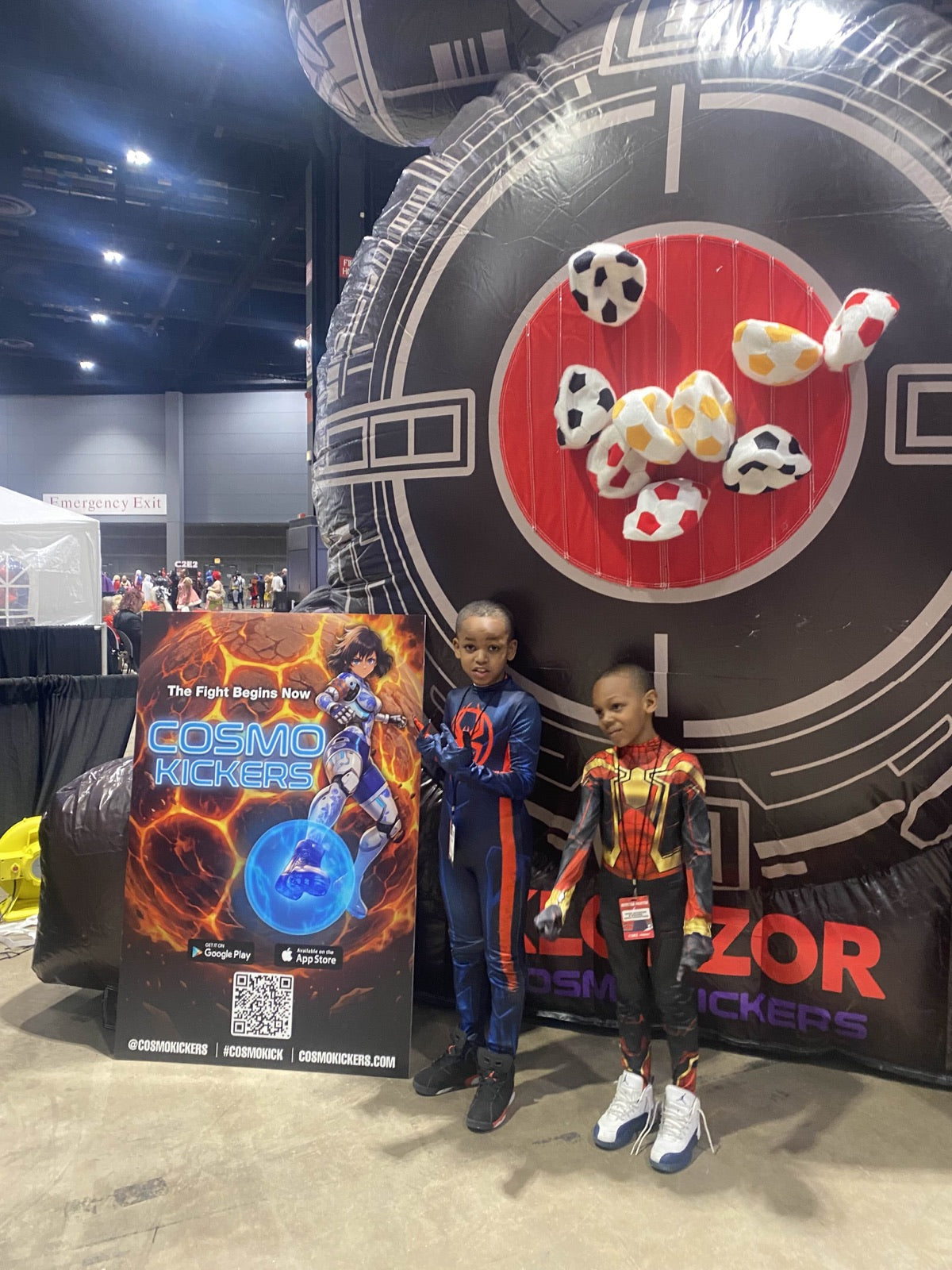 Two children beside a Boss Fight Targets board filled with colorful balls