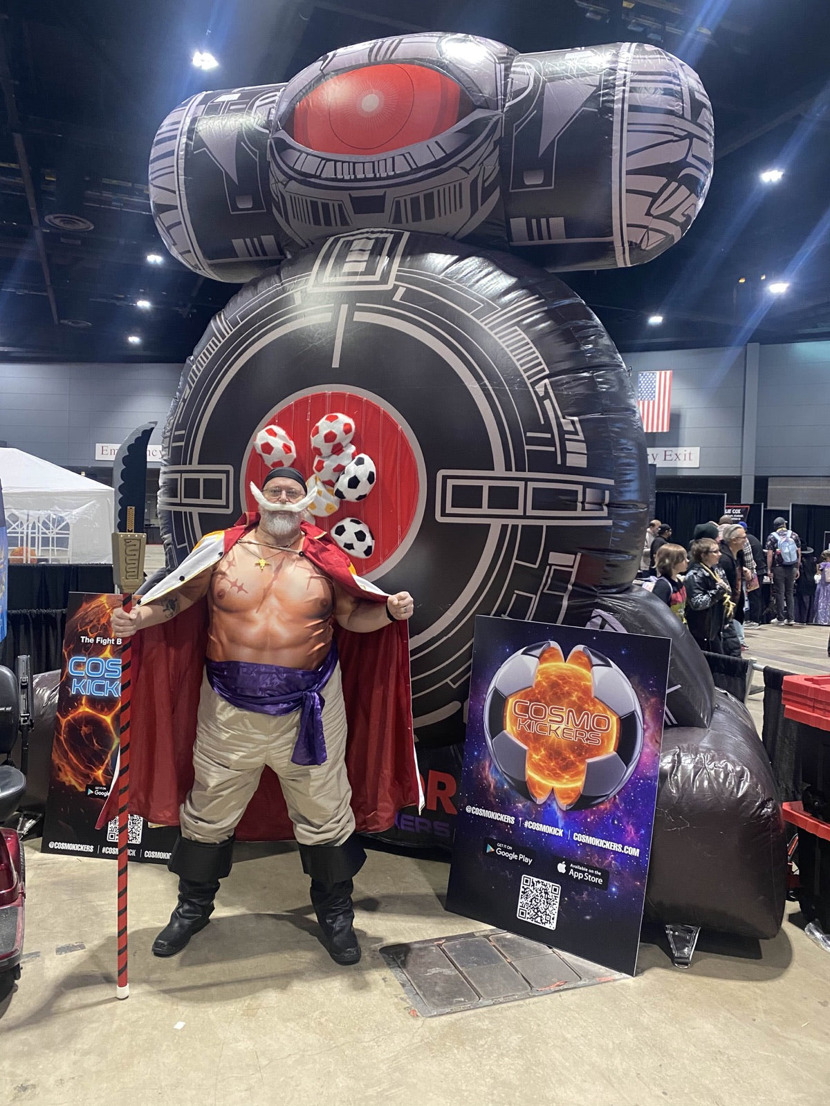 Costumed convention guest standing beside a completed ball target