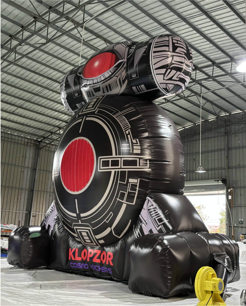 Klopzor inflatable set up in a warehouse with the yellow blower visible